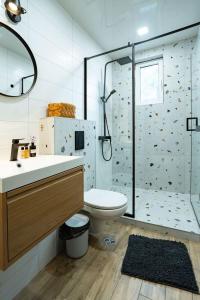 a bathroom with a shower and a toilet and a sink at Cozy in Varna in Varna City