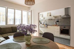 a living room with a table with purple flowers on it at Cozy in Varna in Varna City
