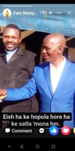 a picture of two men standing next to each other at Bothoba Bed and Breakfast in Maseru