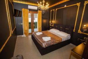 a bedroom with a bed and a chandelier at XVI Secolo House in Scalea