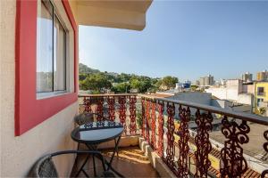 a balcony with a table and a view of a city at Hotel Prainha in Vila Velha