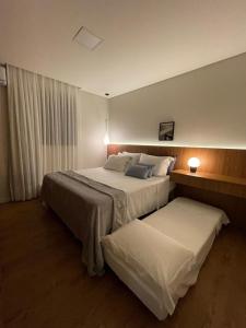 a hotel room with two beds and a window at Apartamento Novo - Conforto no Saguaçú! in Boa Vista