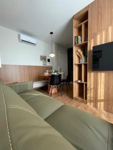 a living room with a couch and a dining room table at Apartamento Novo - Conforto no Saguaçú! in Boa Vista
