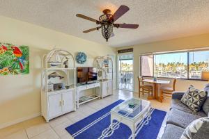 a living room with a couch and a ceiling fan at Waterfront Views and Pool Access Punta Gorda Escape in Burnt Store Marina