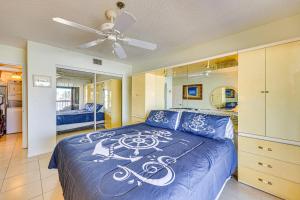 a bedroom with a blue bed and a ceiling fan at Waterfront Views and Pool Access Punta Gorda Escape in Burnt Store Marina +26 photos