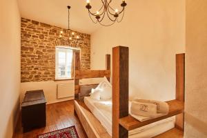 a room with a bed and a brick wall at Burg Honrath in Lohmar