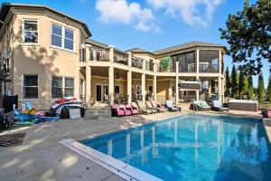a large house with a swimming pool in front of a house at Luxury Lakefront Escape w/ Heated Pool, Hot Tub & Theater in Sunrise Beach