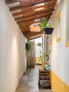 a hallway with a wooden ceiling and plants at CASA TUPI in Ubatuba