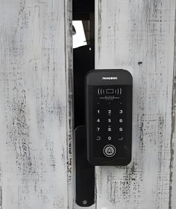 an apple watch is attached to a wooden door at CASA TUPI in Ubatuba