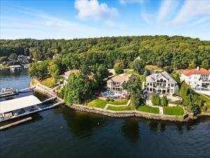an aerial view of a house on the water at Luxury Lakefront Escape w/ Heated Pool, Hot Tub & Theater in Sunrise Beach