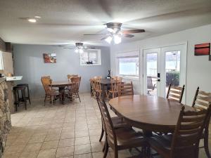 una sala da pranzo con tavoli e sedie in legno di Newly Updated Interior, Sunroom w/ Hot Tub, Deck, Deep Water Dock, Boat & PWC Slips a Buck Creek