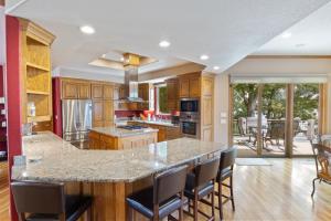 a kitchen with a large island with chairs in it at Pet-Friendly Home In The Main Channel w/ Breathtaking Sunsets & Lake Views in Lake Ozark