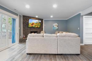 a living room with a couch and a fireplace at Our Cove Retreat - Perfect for Wave-Free Swimming, Tanning & Prime Location Fun! in Lake Ozark