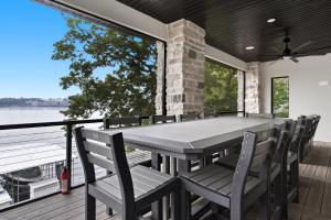 a dining room with a table and chairs on a deck at Huge Private Dock w/ 2 Slips + 2PWC, Beautiful Views, Lakeside Hot Tub, Pool & Pickleball in Laguna Beach