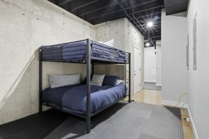 a bunk bed in a room with a concrete wall at Huge Private Dock w/ 2 Slips + 2PWC, Beautiful Views, Lakeside Hot Tub, Pool & Pickleball in Laguna Beach +58 photos