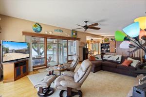 a living room with a couch and a tv at Incredible Views, Fishing, Private Dock & Slip in Laurie
