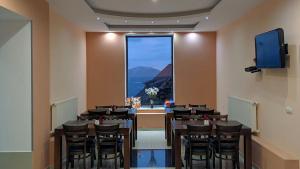 a room with a table and chairs and a window at Hotel Wintera Gudauri in Gudauri