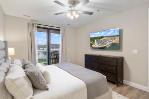 a bedroom with a bed and a ceiling fan at Topsider Experience in the Heart of Osage Beach in Laguna Beach +55 photos