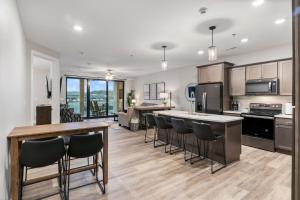 a kitchen with a counter and some chairs in it at Topsider Experience in the Heart of Osage Beach in Laguna Beach