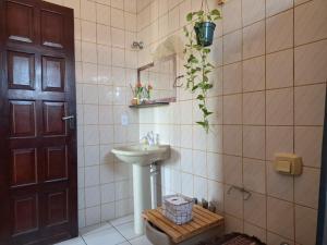 a bathroom with a sink and a mirror at Odoyá Casa Hostel in Arraial d'Ajuda +47 photos