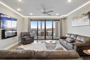 a living room with a couch and a table at Topsider Condo w/ Updated Design & Amazing Main Channel Views in Laguna Beach