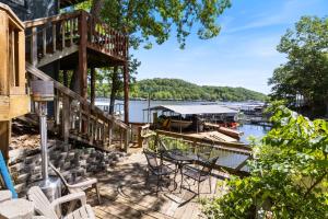 a deck with a table and chairs next to a marina at Wonderful Remote Lake Cabin! Fish from Deck & Dock in Rocky Mount