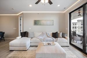 a living room with a couch and a table at Lakefront Topsider Condo w/ Boat Slip, 2 Pools & Large Deck in Laguna Beach