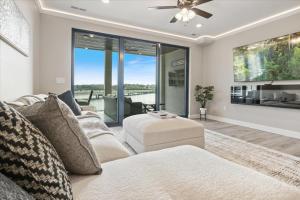 a living room with a couch and a ceiling fan at Lakefront Topsider Condo w/ Boat Slip, 2 Pools & Large Deck in Laguna Beach