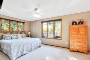 a bedroom with a bed and a ceiling fan at Ideal Cove with Amazing Dock, Kayaks & Fire Pit in Sunrise Beach