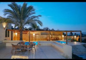 a villa with a swimming pool at night at Sun house in Tunis