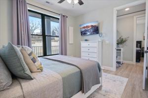 a bedroom with a bed and a large window at Newly Designed Topsider Condo w/ Beautiful Main Channel Views in Laguna Beach +47 photos