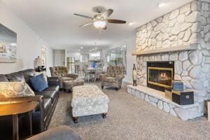 a living room with a large stone fireplace at LazyDays Pet-Friendly Condo w/ Pool & Slip at 3M in Damsel