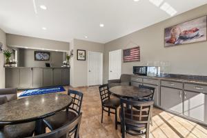 a kitchen and dining room with two tables and chairs at Americas Best Value Inn Byhalia in Byhalia