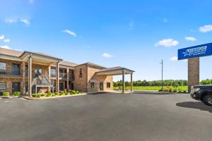 a building with a sign in a parking lot at Americas Best Value Inn Byhalia in Byhalia