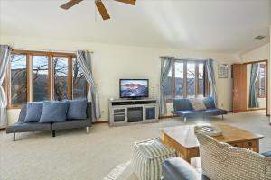 a living room with a couch and a tv at Spacious, Quiet & Great Cove, Nearby Attractions, Private Dock, Fireplace, Expansive Deck in Rocky Mount