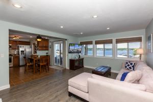 a living room with a couch and a table at Pet-Friendly Condo at MM-19 w/ Boat Slip & Lake Views in Laguna Beach