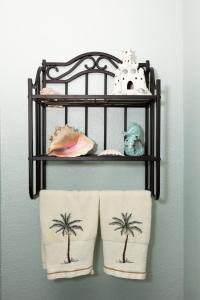 a shelf with two towels with palm trees on it at Pet-Friendly Condo at MM-19 w/ Boat Slip & Lake Views in Laguna Beach +34 photos