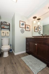 a bathroom with a toilet and a sink at Pet-Friendly Condo at MM-19 w/ Boat Slip & Lake Views in Laguna Beach