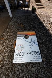 a sign for lake of the ozarks on the ground at Pet-Friendly Condo at MM-19 w/ Boat Slip & Lake Views in Laguna Beach