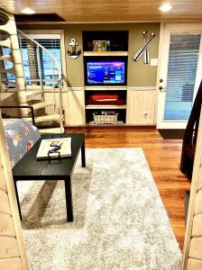 een woonkamer met een tafel en een tv bij Lakefront Oasis with Skylights & Covered Boat Slip For Extra Adventure in Laguna Beach