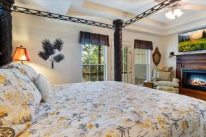 a bedroom with a large bed and a fireplace at Six Suites with Hot Tubs, Private Jacuzzi Baths, Wooded Garden and Lake Access with Boat Slip in Damsel