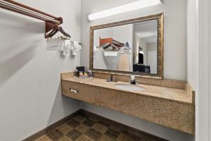 a bathroom with a sink and a mirror at Americas Best Value Inn Byhalia in Byhalia +16 photos