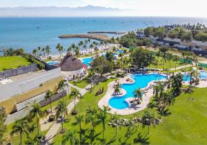 an aerial view of a resort with a pool and the ocean at Casa Oasis B-Nayar Gated, Beach Club, Free Shuttle in Cruz de Huanacaxtle