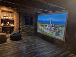 a living room with a large painting on the wall at Cozy Spot in Kutaisi
