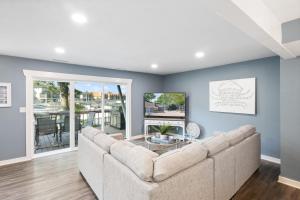 a living room with a couch and a table at Walk to The Strip! Great Cove Water for Lake Fun in Lake Ozark