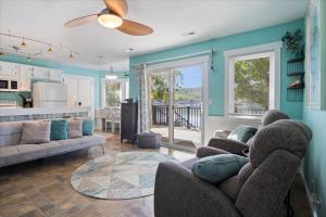 a living room with two couches and a kitchen at Private Dock, Bunkhouse, Firepit & Kayaks at MM45 in Laurie