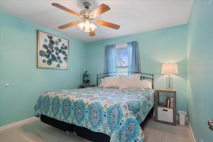 a bedroom with a bed with a ceiling fan at Private Dock, Bunkhouse, Firepit & Kayaks at MM45 in Laurie