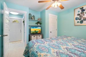 a bedroom with a bed and a flat screen tv at Private Dock, Bunkhouse, Firepit & Kayaks at MM45 in Laurie