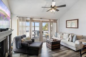 a living room with a couch and a fireplace at Poolside Condo with Amazing Lake Views & Design in Damsel