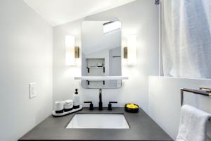 a bathroom with a sink and a mirror at Newly Remodeled w/ Dock, Boat & PWC Slips, Pool Table & Golden Tee in Damsel +70 photos